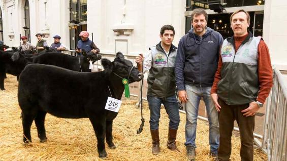 Tomas Gutiérrez, estudiante, Mauricio Groppo, y el decano Marcelo Conrero, con la ternera premiada. (Prensa UNC)